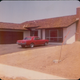 The car in it’s original Candy Apple Red with my mother (the very first owner) in the background